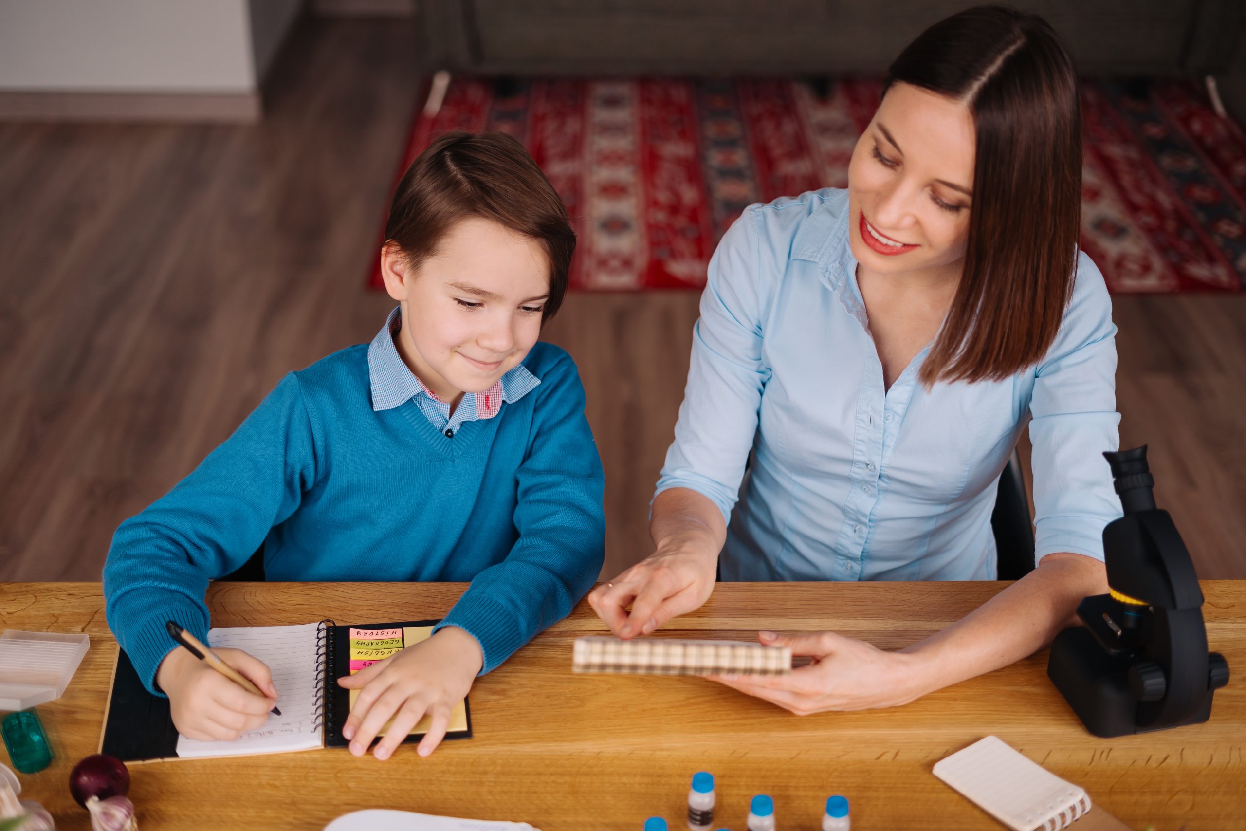 Home learning, woman and boy study at the table